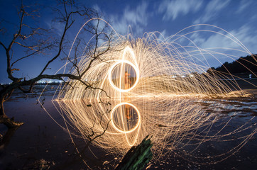 firework swing fire on dead tree fourground 