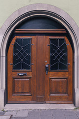 old wooden door, with trim metal ornaments closeup.