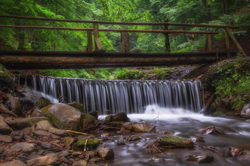 Waterfall in a mountainous area. Threshold. Bridge. Ukraine. Waterfall Shipot.