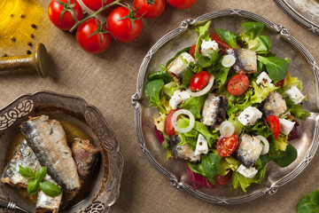A delicious salad with sardines and feta cheese.