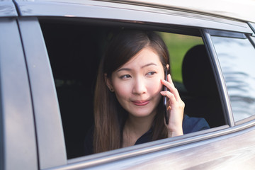 Business Woman Uses Smartphone While sitting in car