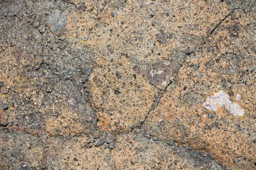 The surface of an old rock with cracks. Old rock texture (wild background)