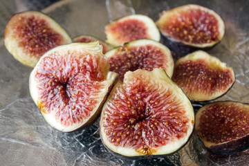 Fresh ripe figs on a silver platter. Concept-  healthy diet, vegetarianism, Mediterranean diet. Selective focus.