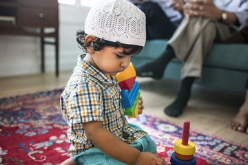 Muslim family relaxing and playing at home