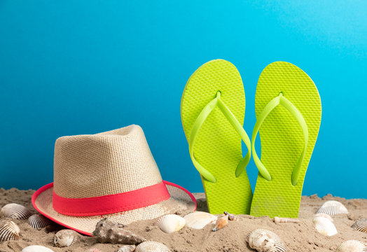 strand hat with flipflop and shellfish blue background