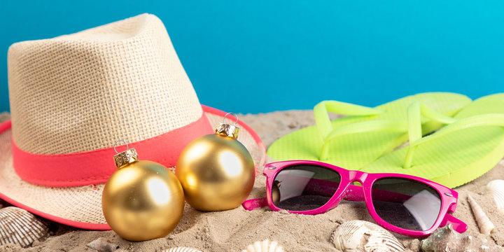 flip flops with sunglasses and strand hat and christmas balls