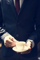Businessman holding coffee cup