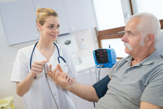 Nurse Preparing A Device Attached To The Finger