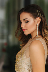 Girl close her eyes and show her beutiful makeup and hairstyle