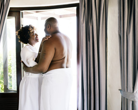 Couple standing together in hotel room