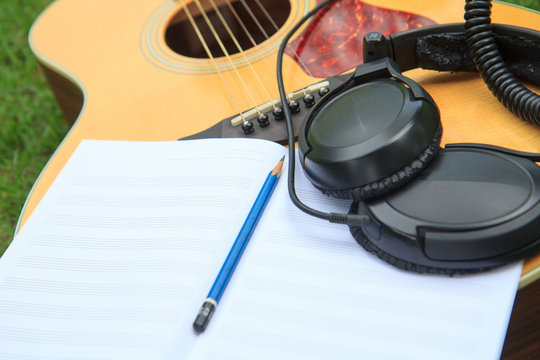 staff book for write note of song with use acoustic guitar for play
