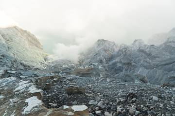Extraction of sulfur in the crater of a volcano. Sulfur gas, smoke. Kawah Ijen, crater with acidic crater lake where sulfur is mined. Ijen volcano complex is a group of stratovolcanoes in the