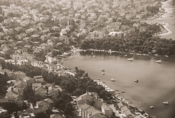 Black and white photo view of coastal town with boats.