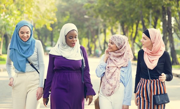 Islamic Women Friends Walking And Discussing Together