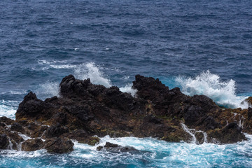 Waves crashing against a rocky coast in Atlantic ocean