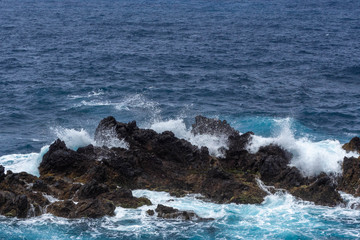 Waves crashing against a rocky coast in Atlantic ocean