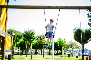 child plays on the swing in the park