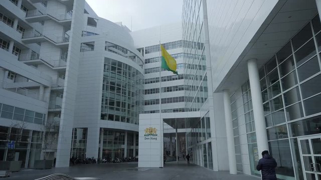 Wide shot of the flag of The Hague at the city hall. Shot in sixty frames per second variable frame rate.
