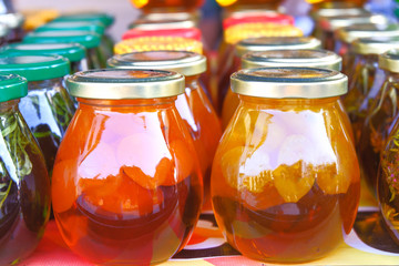 A cup of herbal tea with fresh mint, honey, lemon, ginger on rustic white wooden background. Top view, copy space