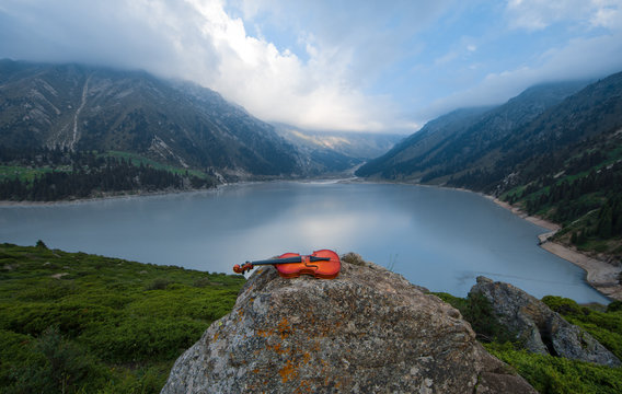 violin on the background of Mountain Lake