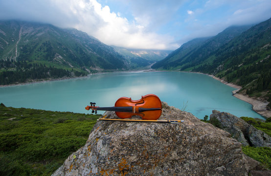 violin on the background of Mountain Lake
