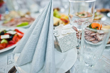 Close-up photo of wedding cutlery on the decorated table.