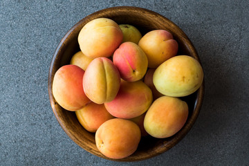 Raw Ripe Organic Orange Apricots in Wooden Bowl.