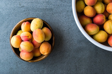 Raw Ripe Organic Orange Apricots in Wooden Bowl.