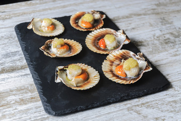 Galician style queen scallop dish, classic spanish tapas dish.selective focus.