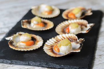 Galician style queen scallop dish, classic spanish tapas dish.selective focus.