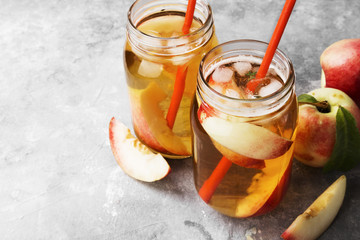 Peach ice tea on a gray background. Copy space. Food background