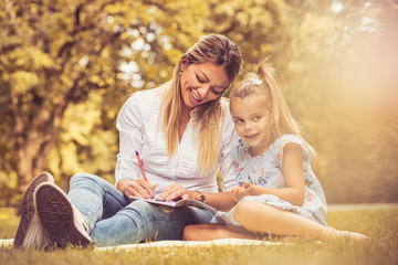 Fototapeta premium Family time. Mother and daughter at public park.