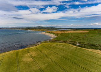 aerial view of lush green rural farmland and beach landscape on the west coast of Ireland
