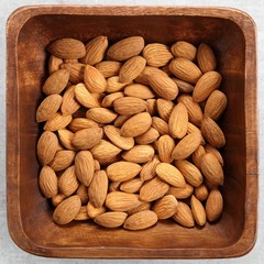 Almonds in wooden bowl.