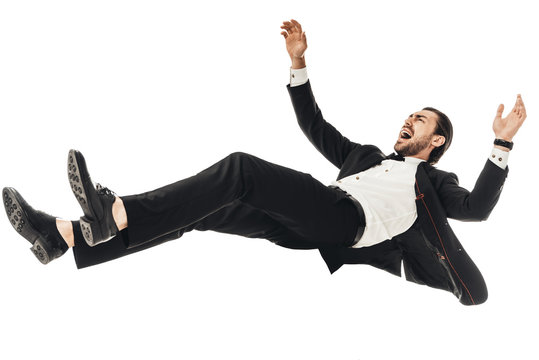 Scared Young Businessman In Suit Falling Isolated On White