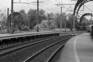 Railroad tracks for the train. In the area of the pen. Brilliant rails go nowhere. Black and white photo of the railway platform.