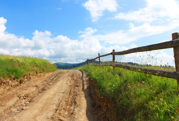 Landscape with a country road and a fence.