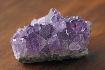 Amethyst stone. Natural Amethyst stones of minerals on a background of natural wood American black...