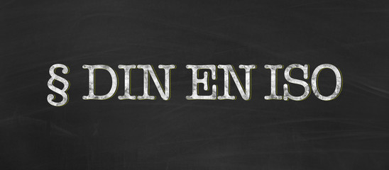 DIN EN ISO for german, european and international standard organization with chalk on blackboard background as banner - 214081339