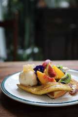 Dessert baked Waffle with fruits kiwo grape berry and vanilla ice cream vintage style