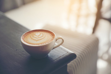 cappuccino or Latte art coffee made from milk on the wood table in coffee shop