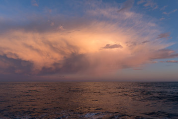 Stormy clouds of contrasting color over sea