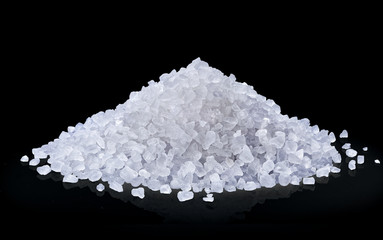 heap of salt isolated on black background.