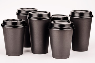 black paper cups on white background.