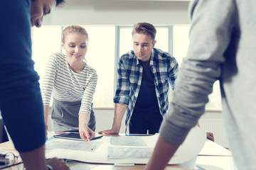 Lets check. Young beautiful female pointing at necessary information and keeping smile on her head...