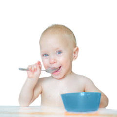 Baby eating and smiling, isolated