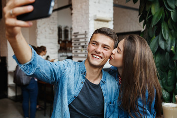 Fototapeta premium Couple Taking Photos With Coffee In Cafe