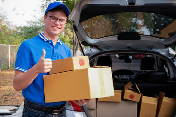 Delivery man show thumb up to service delivering package box , delivery concept