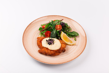 Top and front view isolated - Chicken parmesan cheese and mixed salad.