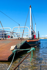 Ferry awaiting to taking cars and passengers to the other side of a lade
